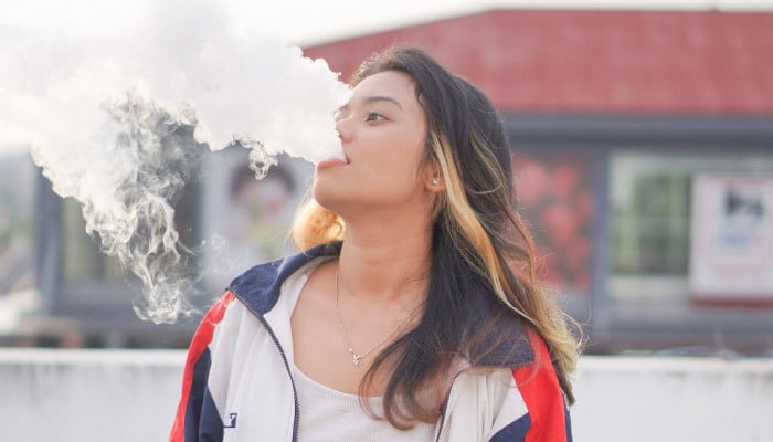 Woman using Delta 8 THC-P Vape near Huntington Beach, California ordered from Simple Garden.