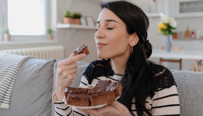Woman eating Delta 8 Chocolate in Boston, Massachusetts, purchased online from Simple Garden.