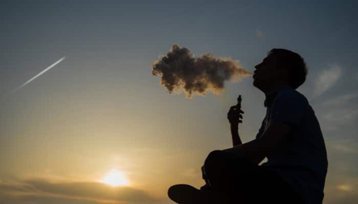 Silhouette of man outside using a Boston THC Vape from Simple Garden.