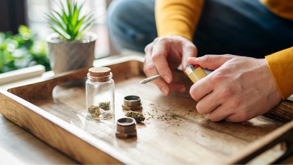 A man preparing to smoke flower he bought as part of our Michigan Road/Traders Point, Indianapolis Black Friday THC specials.